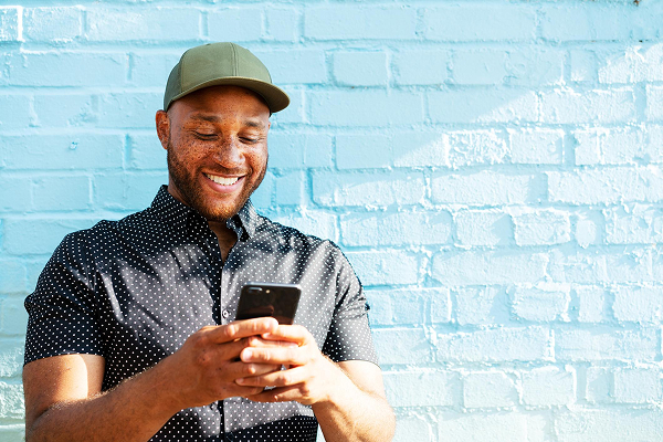 man-with-cap-on-mobile-phone.jpg
